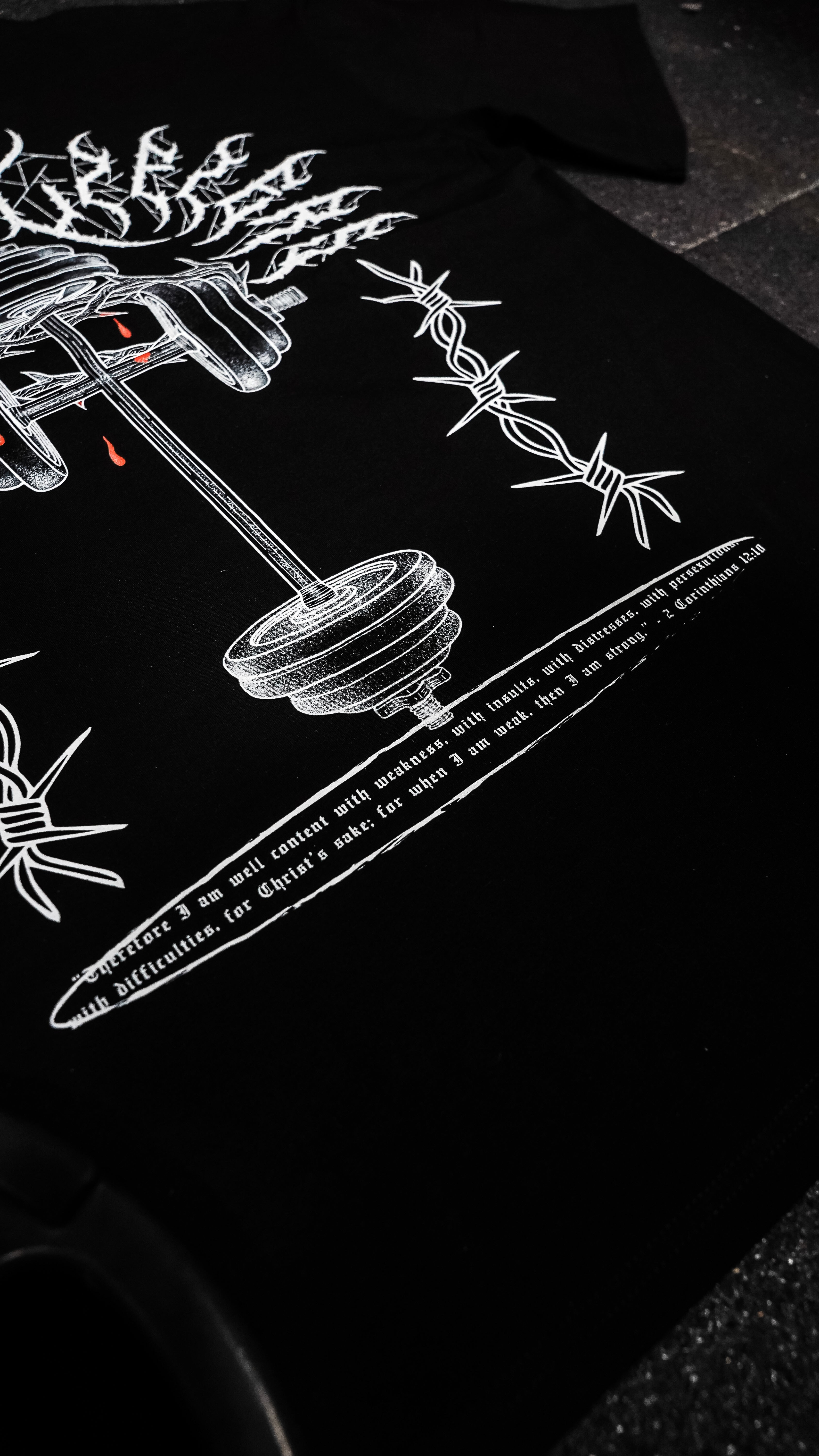 Black t-shirt with white graphic design on a dark surface