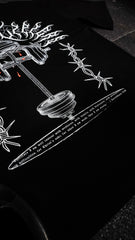 Black t-shirt with white graphic design on a dark surface